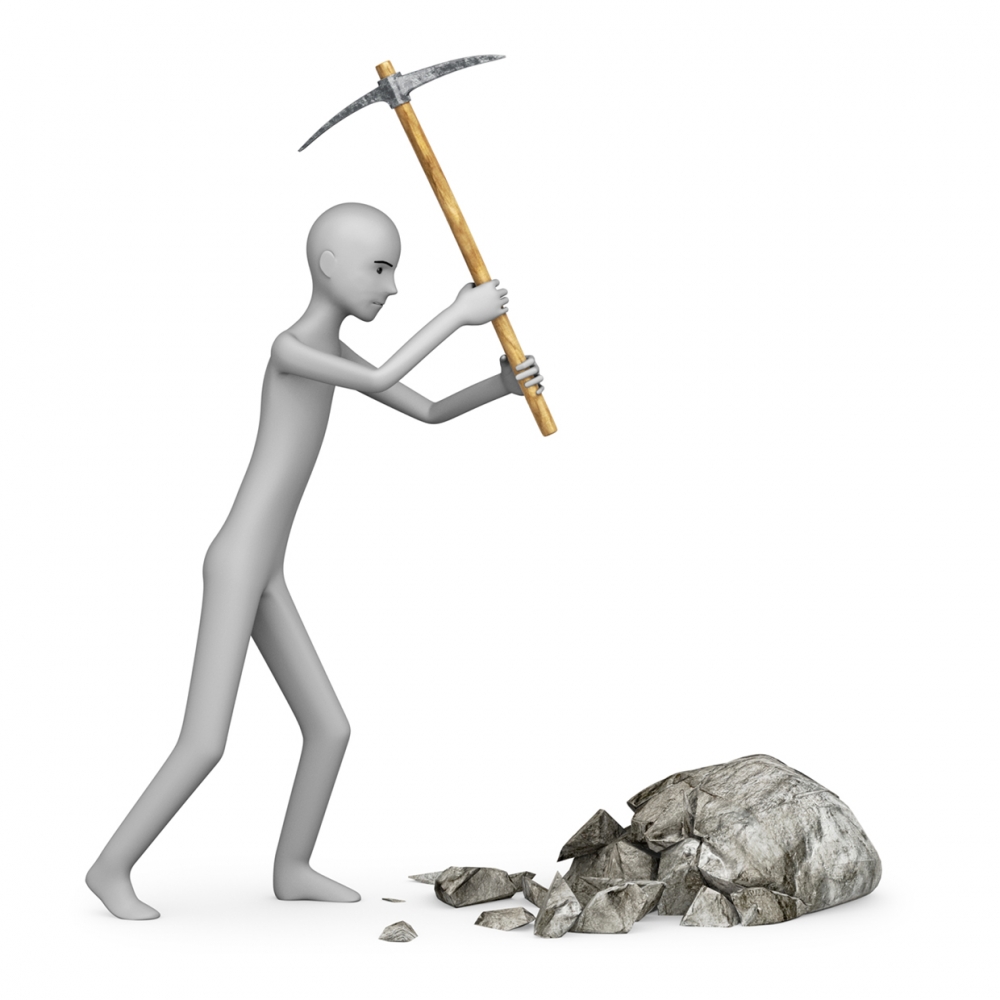 Imagen en la que se ve una persona golpeando una piedra con un pico