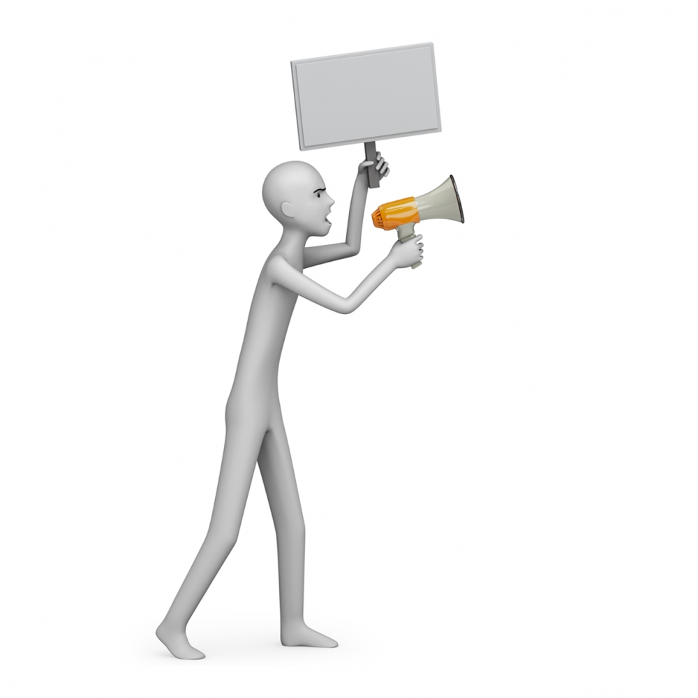 Imagen en la que sale una persona protestando con una pancarta y un megáfono