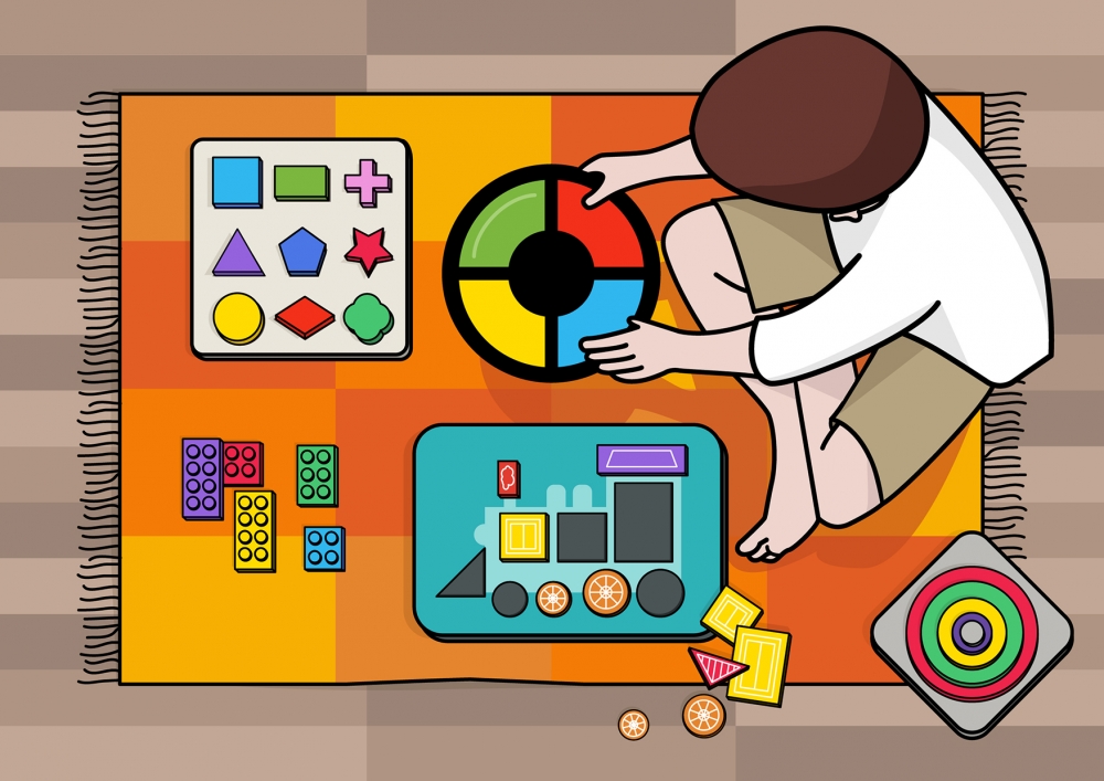 Un niño juega en la alfombra con sus juguetes