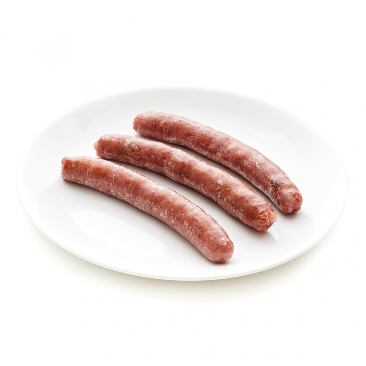 Imagen en la que se ve un plato con tres salchichas ya cocinadas