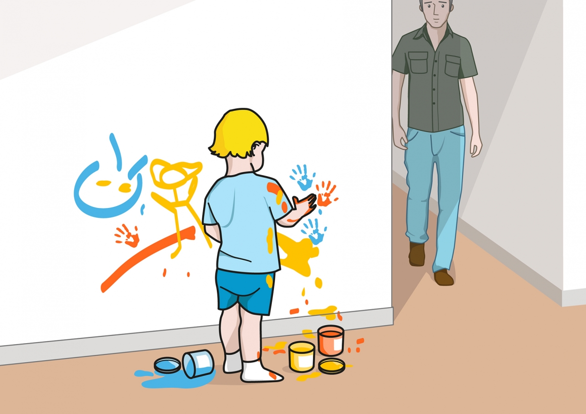 El bebé pinta la pared con pintura de dedos